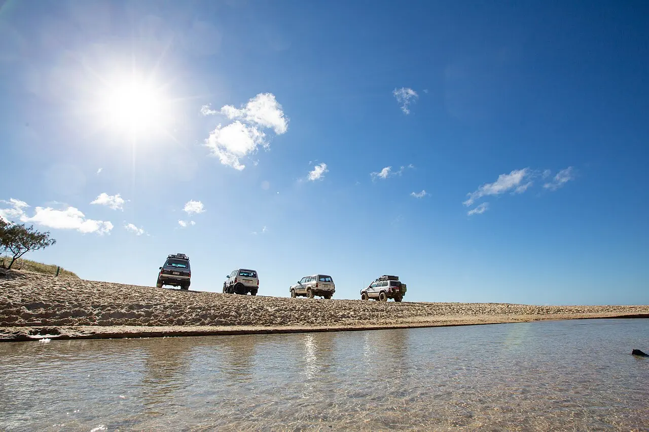 Four-wheel-drive vehicles parked near Eli Creek